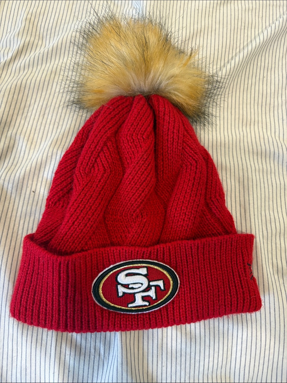 New Era Red Knit Beanie with Tan Faux Fur Pom and SF Team Patch